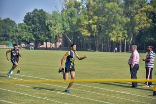 Aitchison Dominates First Day's Athletics Against Lawrence