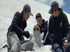 Trekkers having fun with mini snowman